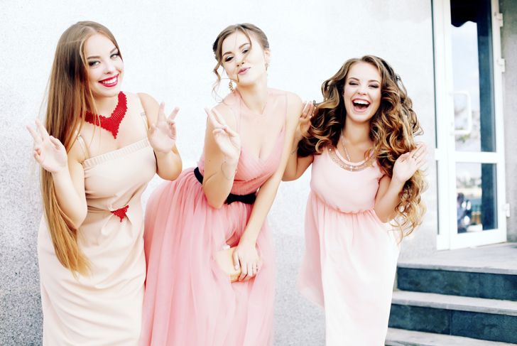 Three happy beautiful brides together. Party time of stylish women group in elegant dress celebrating birthday, having fun, wedding, prom. Friends posing for the camera